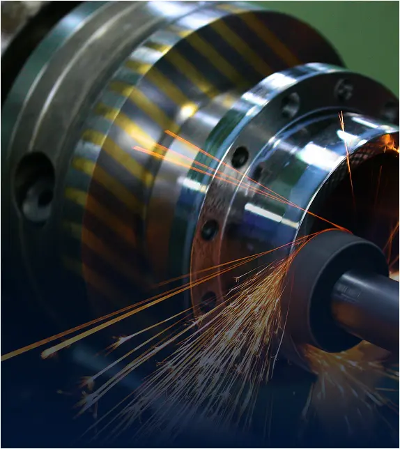 Sparks flying as a grinding tool finishes a flanged rotating part
