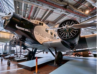 Vintage propeller aircraft on display inside a hangar-style museum