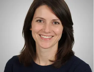 Kelly Martinez, smiling woman with shoulder-length dark hair