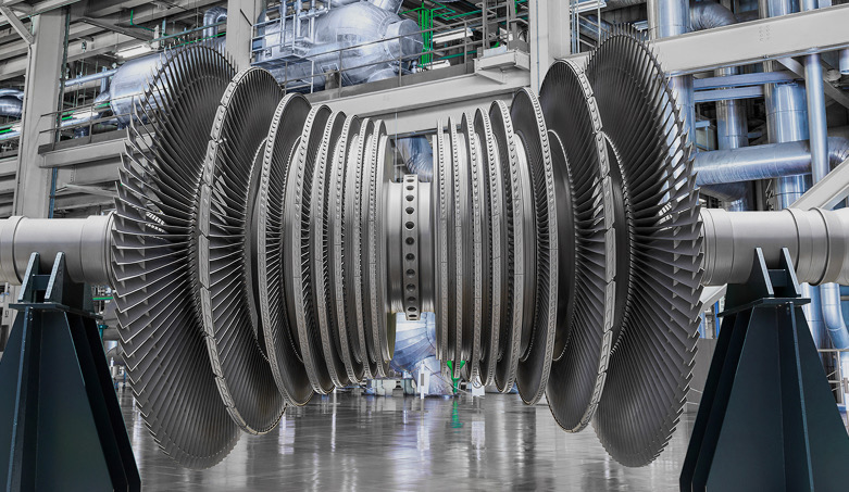 Steam turbine rotor with multiple blade stages supported on stands in a power plant